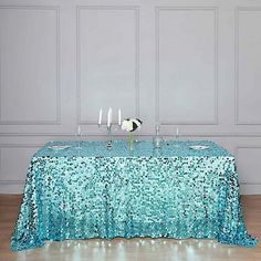 a blue table cloth with silver sequins on it