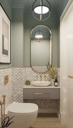 a white toilet sitting next to a bathroom sink under a round light above a mirror