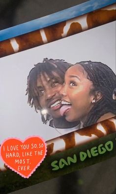 an advertisement on the back of a cell phone shows a man and woman with dreadlocks