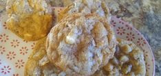 three cookies sitting on top of a red and white plate