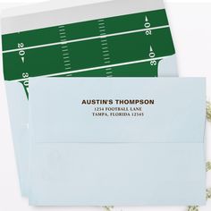 two envelopes with green and white football field on them, one for the team