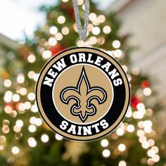 a new orleans saints ornament hanging from a christmas tree