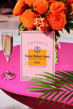 there is a pink table with orange flowers and a sign on it that says verant's