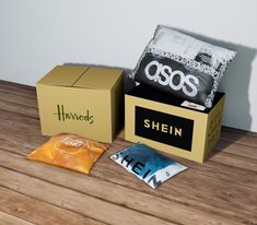 an open box with some items in it on a wooden table next to a bag