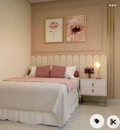 a white bed sitting next to a wall with two pictures on the wall above it