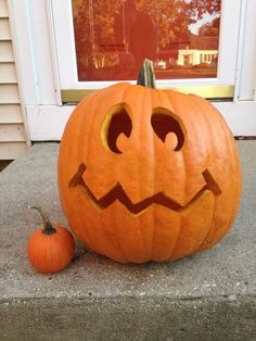 a carved pumpkin sitting on the front porch