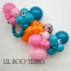 there are balloons that look like animals with googly eyes on their heads, and the words lil boo thang above them