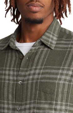 Rugged style and comfort combine in a relaxed-fit plaid sport shirt made with a softer texture than your average button-up. 29 1/2" length; 23" chest Spread collar Long sleeves with button cuffs 55% cotton, 45% rayon Machine wash, line dry Imported Casual Yarn-dyed Button-up Flannel Shirt, Plaid Relaxed Fit Yarn-dyed Shirt, Plaid Yarn-dyed Shirt Relaxed Fit, Plaid Yarn-dyed Shirt With Relaxed Fit, Plaid Yarn-dyed Relaxed Fit Shirt, Casual Plaid Yarn-dyed Flannel Shirt, Collared Plaid Tops For Outdoor, Classic Plaid Tops For Casual Gatherings, Plaid Collared Tops For Outdoor