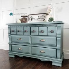 an old dresser is painted blue with silver knobs