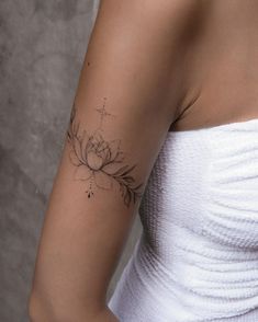 a woman with a flower tattoo on her arm