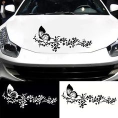 a white car with black flowers and butterflies on the front bumper sticker, next to it