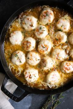 a skillet filled with meatballs covered in gravy