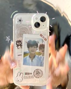 a person holding up a cell phone case with an image of a boy on it