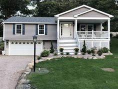 a gray house with white trim and blue shutters on the front door is shown