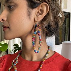 A small circle of colorful Kantha beads interlocks with an oval-shaped loop of Kantha beads to form this fabulous statement earring style. Finished with nickel-free/lead-free French earring wires. Sustainably handmade by women artisans in India. Artisan Multicolor Round Beaded Earrings, Multicolor Fair Trade Beaded Earrings, Handmade Bohemian Multicolor Wrap Earrings, Multicolor Drop Wrap Earrings, Multicolor Circular Beaded Earrings With Ear Wire, Multicolor Beaded Circle Earrings, Handmade Multicolor Circular Jewelry, Multicolor Teardrop Hoop Earrings, Handmade Multicolor Teardrop Hoop Earrings