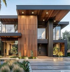 a modern house with large windows and wooden accents on the front door, surrounded by palm trees