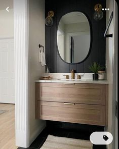 a bathroom with a sink, mirror and rug on the floor in front of it