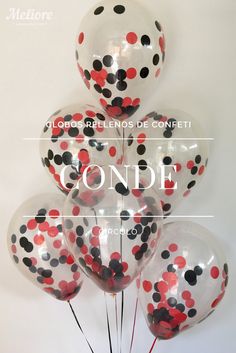 a bunch of balloons that have been decorated with black and red polka dots on them