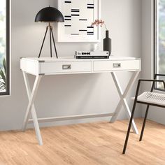 a white desk with two drawers and a lamp next to it on a hard wood floor