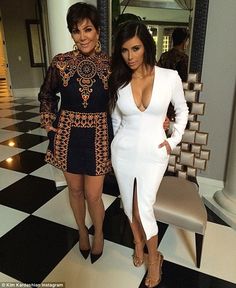 two women standing next to each other on a checkered floor