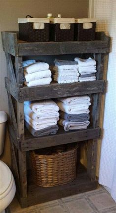 towels are stacked on top of an old wooden shelf