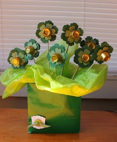 a green bag filled with flowers on top of a wooden table