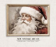 a painting of santa claus wearing a red suit and hat with the words, new vintage art co