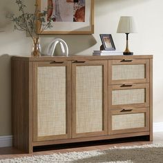 the sideboard is made from wood and has two drawers, one with three baskets on it