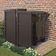 a large trash can sitting in front of a brick building next to a flower garden