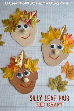 three paper faces with leaves on them