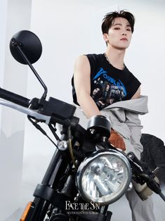 a young man sitting on top of a motorcycle