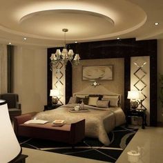 a bedroom with a large bed and chandelier