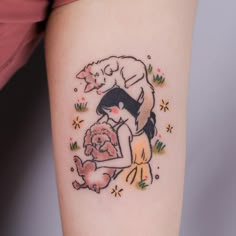 a woman with a dog tattoo on her arm holding a teddy bear and wearing a hat