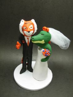 a wedding cake topper with a bride and groom in the shape of a fox