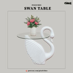 the swan table has flowers on it and is next to a vase with roses in it