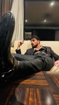 a man sitting on a couch with his feet up