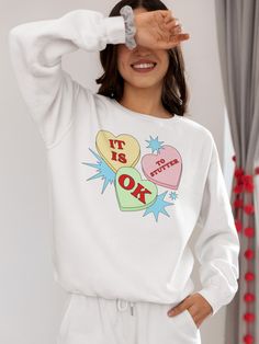 ✨This cute Valentine's Day candy “It Is OK to Stutter” Gildan 18000 unisex sweatshirt is an ideal gift for yourself and friends or relatives who stutter and their stuttering allies. It’s the perfect way to self-advertise that you stutter and to advocate for people who stutter everywhere with a reminder that they're not alone. A portion of the proceeds will go towards National Stuttering Association (NSA) support groups - thanks for supporting the Normalize Stuttering movement! ✨Ideal for any sit Cute Graphic Print Sweatshirt For Gift, Casual Heart Graphic Sweatshirt Gift, Valentine's Day Casual Long Sleeve Sweatshirt, Casual Long Sleeve Sweatshirt For Valentine's Day, Cute Valentine's Day Graphic Print Sweatshirt, Trendy Valentine's Day Crew Neck Sweatshirt, Valentine's Day White Crew Neck Sweatshirt, White Crew Neck Sweatshirt For Valentine's Day, Valentine's Day White Casual Sweatshirt