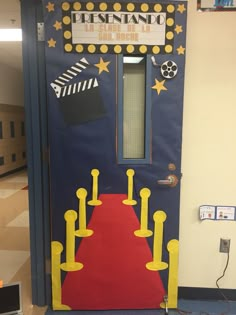 a door decorated to look like it is going down the red carpet and yellow barriers