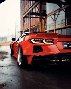 a red sports car parked in front of a building