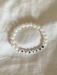 a bracelet that says i love taylor with pearls and a heart on the bead