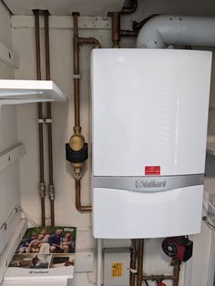 a tankless water heater sitting on top of a kitchen counter