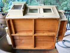 an old wooden cabinet sitting on top of a metal table