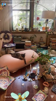 a living room filled with lots of clutter and decor on top of a wooden floor