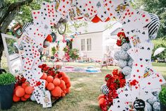 an outdoor area decorated with cards and balloons