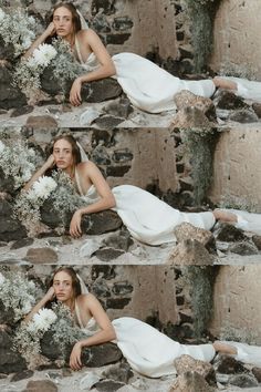 a woman laying on the ground with flowers in her hair and wearing a white dress