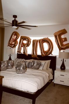 a bedroom with balloons that spell out bride