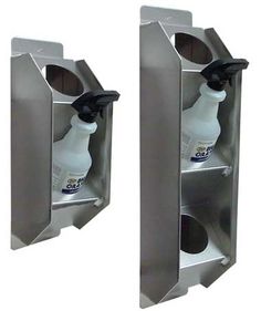 two stainless steel wall mounted soap dispensers with one bottle in the middle