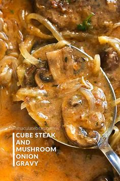 a spoon full of meat and mushroom gravy with the words, cube steak and mushroom onion gravy