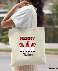 a woman carrying a tote bag that says merry christmas