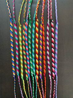 multicolored braids are hanging on the wall